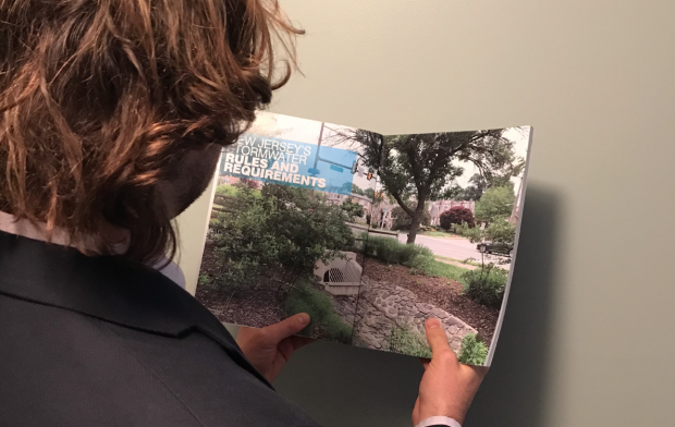 Person reading the New Jersey Developers Green Infrastructure Guide 2.0 